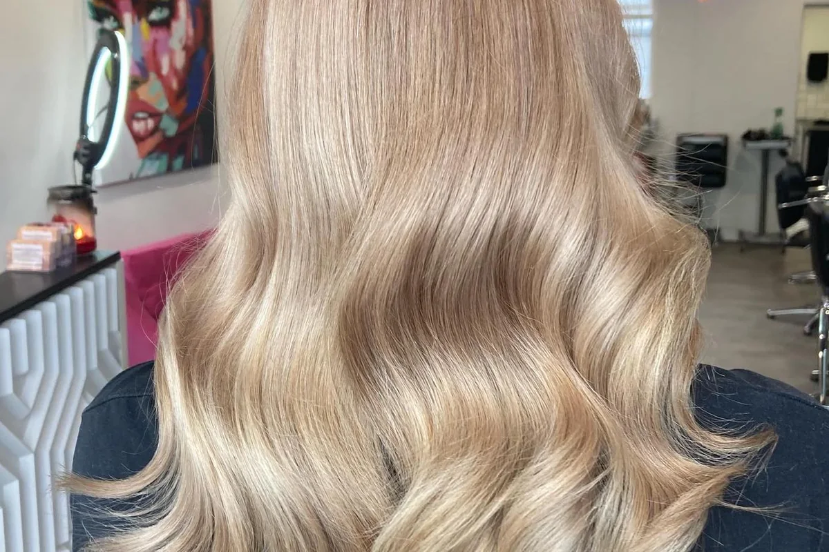 Soft blonde balayage with polished waves