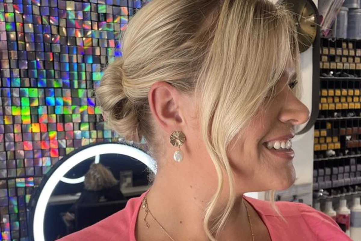 Soft blonde updo with loose face-framing pieces