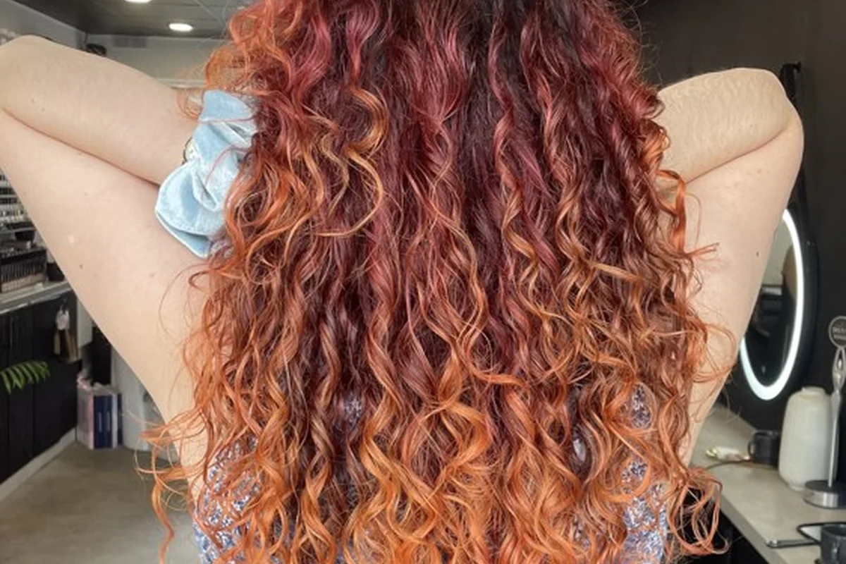 Copper and red colour through naturally curly hair