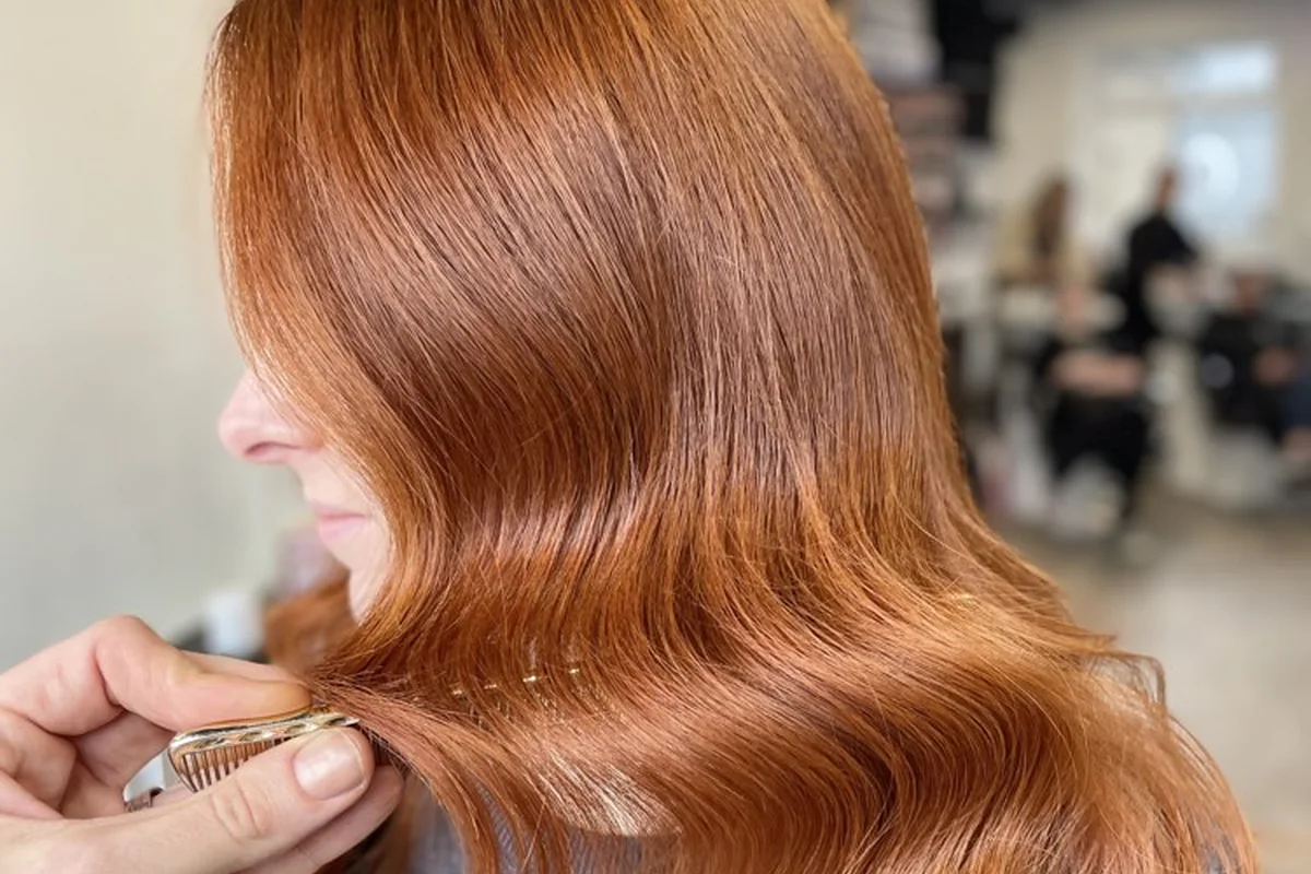 Rich copper hair styled in glossy waves