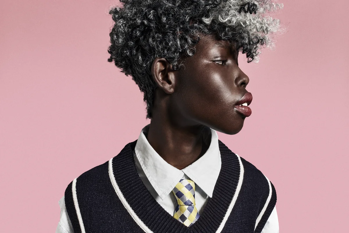 An editorial portrait showing a short textured haircut