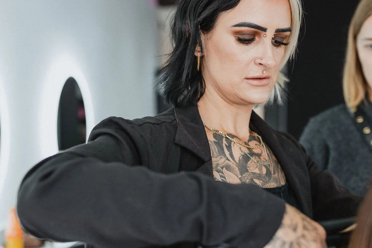 A stylist carefully brushing a client’s hair