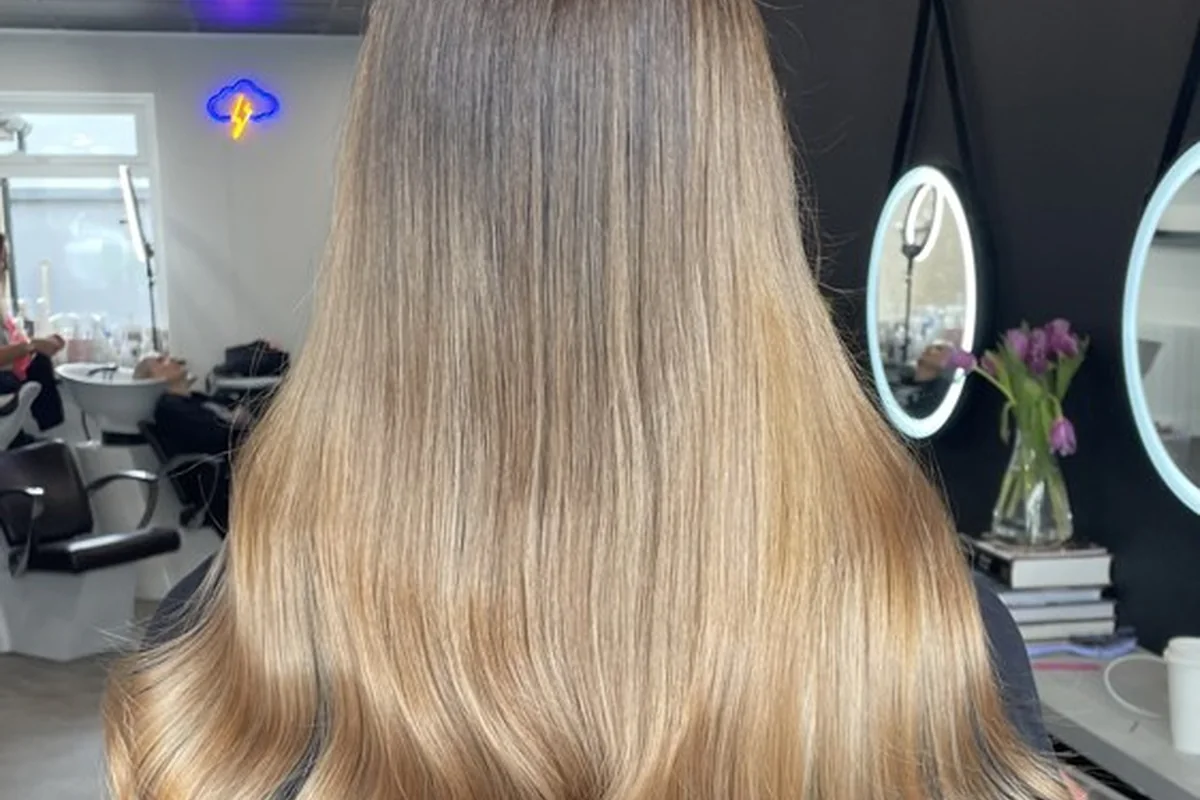 Long blonde hair with a softly waved finish