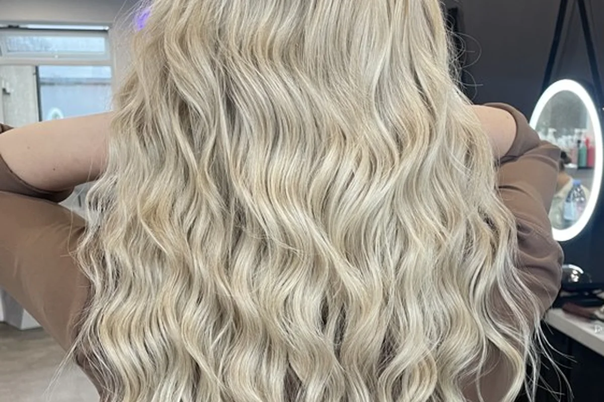 Blonde curls viewed from the back in the salon