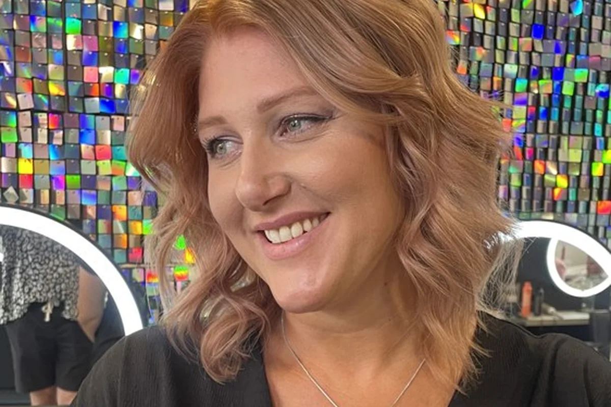 Warm copper hair framing a smiling client’s face